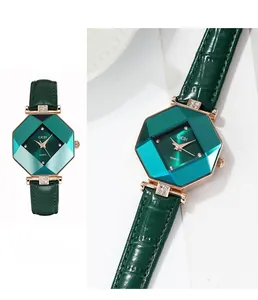 Macro shot of emerald octagonal quartz watch with rose gold diamond case and leather strap