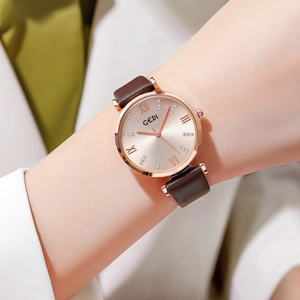 Elegant rose gold women's quartz watch with a brown leather strap and champagne dial