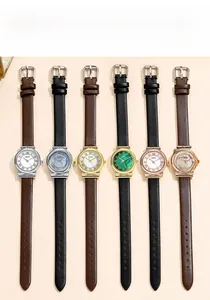 Detailed view of women's quartz watches with leather straps and Roman numeral dials