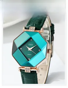 Detail of octagonal green emerald cut crystal watch face with rose gold case