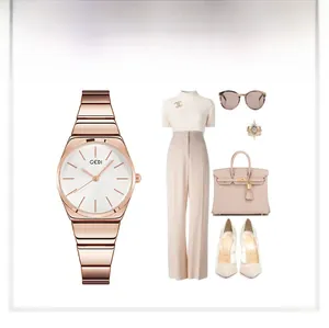 Elegant rose gold bamboo style watch paired with a chic office outfit and accessories