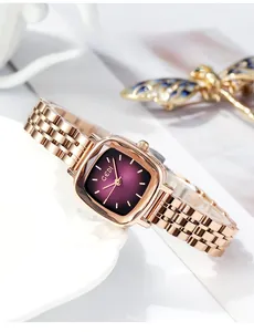 Detail of rose gold square watch with purple gradient dial and metal chain strap