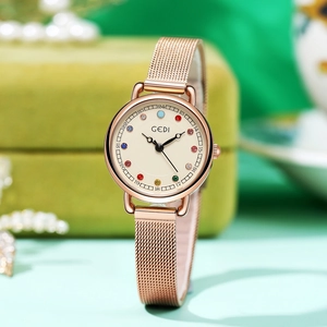 Elegant rose gold quartz watch with colorful zircon markers on green velvet jewelry box