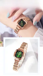 Close-up of rose gold square watch with green sunray dial and sleek metal bracelet