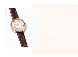 Detail of rose gold watch with crystal bezel and brown crocodile leather strap