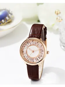 Detail of starry dial with crystal markers and brown crocodile leather strap on women watch