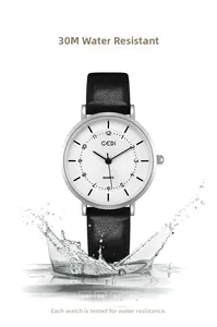 Macro shot of quartz watch dial with black leather strap showing splash-proof water effect