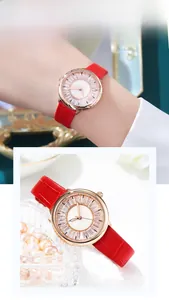 Detail of elegant ladies watch with red leather strap and rose gold crystal bezel