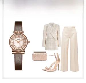 Close-up of mother-of-pearl dial watch with Roman numerals and brown leather strap