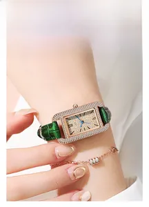 Detail of square quartz watch with rhinestones and green crocodile leather strap