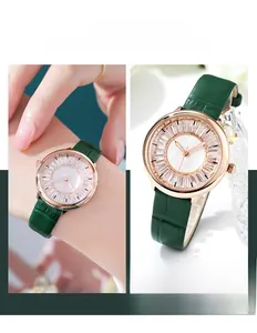 Detailed view of rose gold quartz watch with starry dial and green leather strap