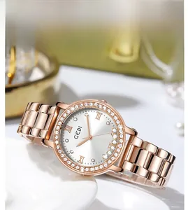 Macro detail of rose gold watch bezel and silver dial with Roman numerals and zircons