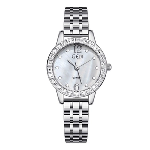 Detail of silver women's watch with mother-of-pearl dial and rhinestone-set bezel