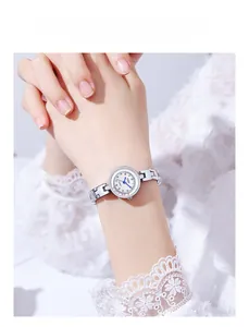 Elegant silver bracelet watch with white dial and blue hands on model's wrist