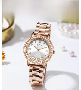 Close-up of luxury women's watch with rose gold strap and sparkling rhinestone bezel