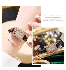 Detail of square rose gold watch with crystal bezel and embossed leather strap