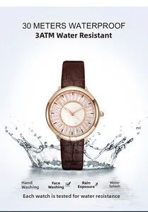Detail of waterproof watch with brown leather strap and rose gold case showing water splash