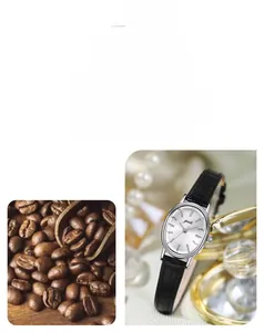 Close-up of elegant oval women's watch with silver sunray dial and black leather strap