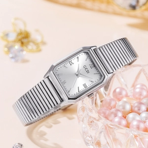 Elegant silver square quartz watch with Roman numerals on a bed of pink pearls