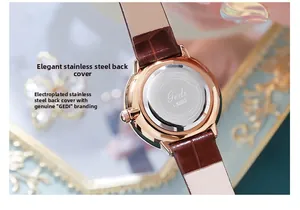 Close-up of engraved stainless steel case back and brown leather strap of quartz watch