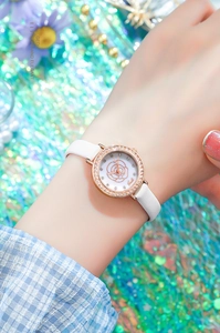 Close-up of elegant rose gold watch featuring a diamond bezel and floral pattern dial