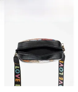 Detail of multi-color quilted crossbody bag with zip closure and LOVE rainbow strap