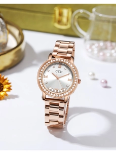 Close-up of rose gold watch with sparkling rhinestone bezel and floating dial crystals