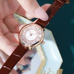 Fashionable women's rose gold watch with starry dial and brown crocodile leather strap