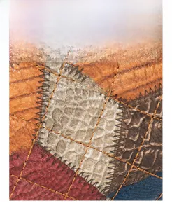 Macro shot of patchwork leather texture with contrast stitching and mixed patterns