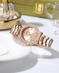 Macro shot of rose gold starry dial watch with rhinestone bezel on elegant porcelain decor