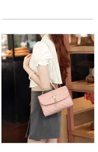 Pink quilted chain bag with tassel and pearl circular hardware detail on the flap