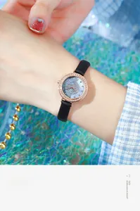 Detail of rose gold watch featuring a floral pattern dial and diamond-encrusted bezel