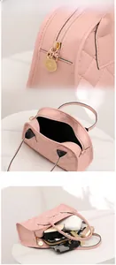 Close-up of pink quilted handbag showing zipper detail and spacious interior storage
