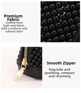 Detail of high-quality black beaded texture and smooth gold metal zipper on a shell bag