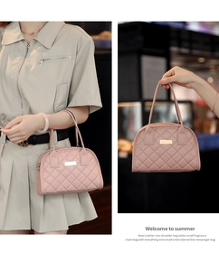 Detail view of pink quilted handbag with sleek metal plaque and fine stitching
