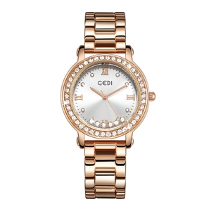 Macro view of rose gold watch dial with Roman numerals and sparkling crystal bezel