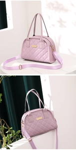 Detail of lavender quilted faux leather tote bag with gold hardware and wide strap
