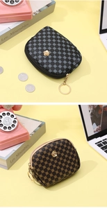 Detail of vintage small leather pouches in black and brown with golden floral metal hardware