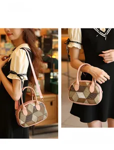 Detail of pink plaid handbag showing geometric pattern and detachable shoulder strap