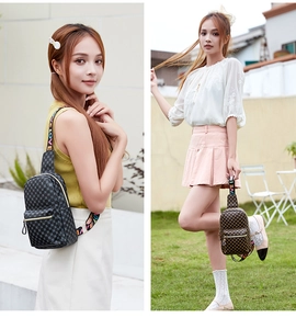 Close-up of printed crossbody sling bags with wide colorful LOVE letter straps and zippers