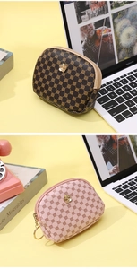 Detail of floral printed PU leather zip coin purses in brown and pink with gold flower clasp