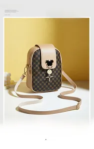 Detail of a vintage floral pattern mini shoulder bag with a metal mouse-shaped clasp