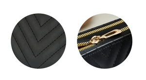 Detail showing premium black chevron quilted leather and high-quality gold metal zippers