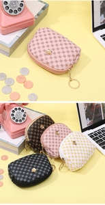 Detail of semi-circular zipper coin purses with floral embossing and gold rose accents