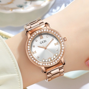Elegant rose gold ladies watch with rhinestone bezel and silver sunray dial on wrist