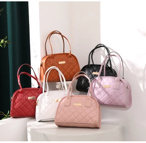 Quilted handbags in various colors displayed on white pedestals with gold hardware