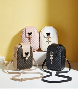 Detail of four patterned phone bags with Mickey-shaped metal clasps and star pendants