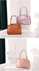 Quilted tote bags in various colors displayed on a marble table with elegant soft lighting