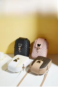Close-up of quilted PU leather crossbody phone bags with mouse head metal fasteners