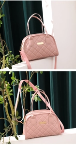 Detail of pink quilted shell bag featuring gold metal plaque and premium leather texture